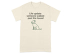 Cream t-shirt with a dog graphic and text "Life update: someone walked past the house!"
