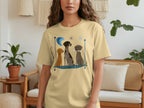 Cream t-shirt with graphic of three dogs sitting on a blue mat.