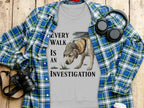Gray t-shirt with a dog investigating and text "Every Walk is an Investigation".