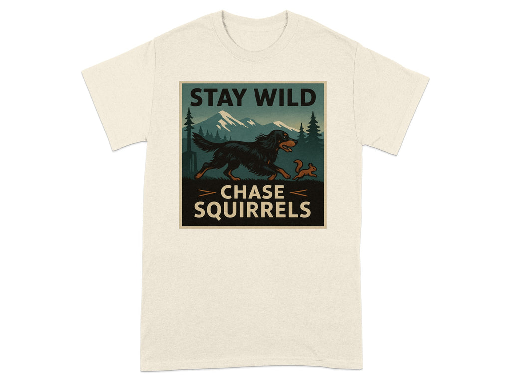 T-shirt graphic with black dog chasing squirrel, mountains, trees, and text "STAY WILD CHASE SQUIRRELS".