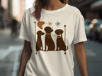 Three brown dogs sit in a row on a t-shirt graphic with playful shapes.