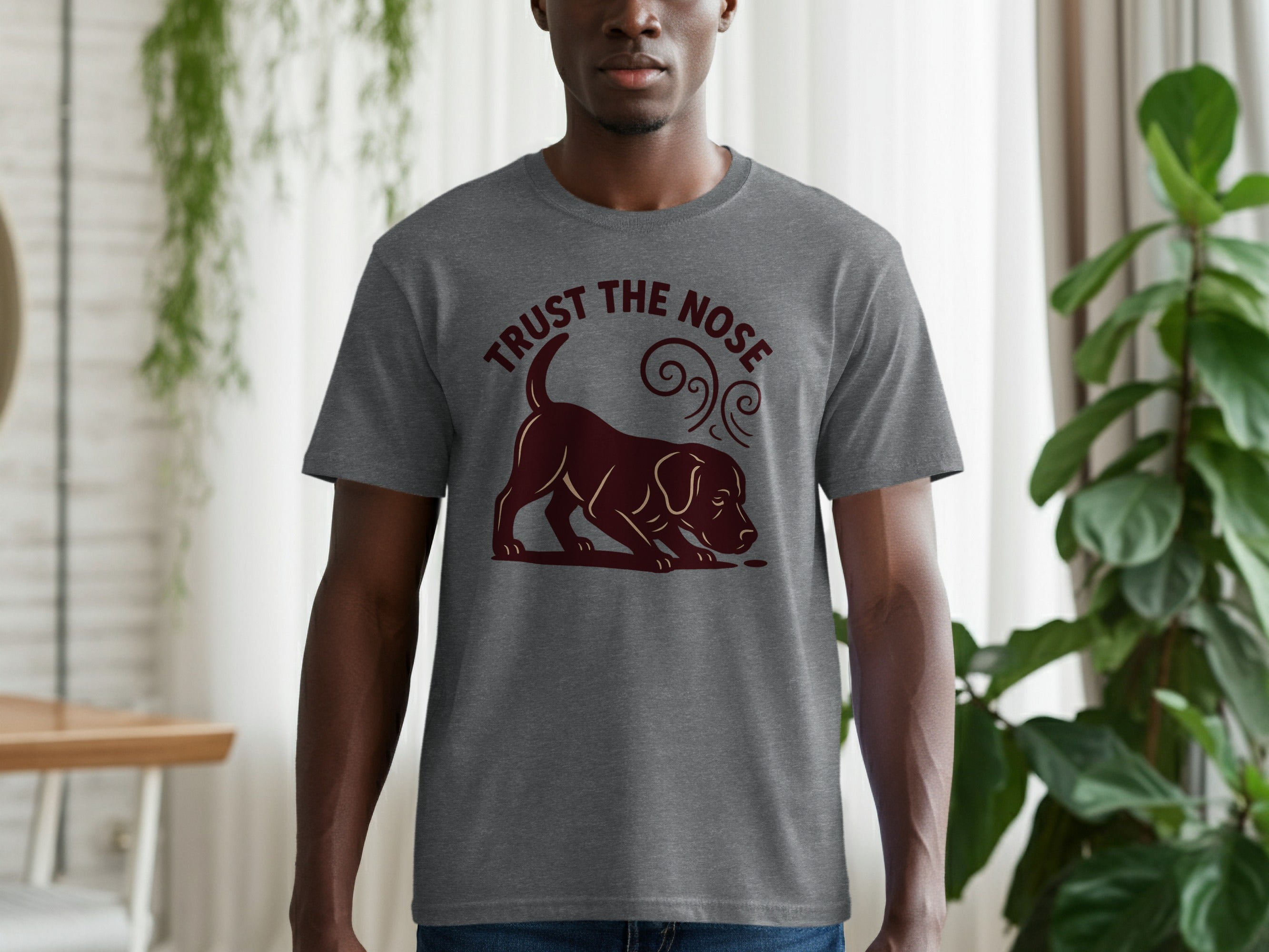 Grey t-shirt with a dark brown graphic of a dog sniffing with text "TRUST THE NOSE".