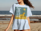 White t-shirt with graphic of yellow lab dog, sun, and text "LAB DAYS ARE THE BEST DAYS".