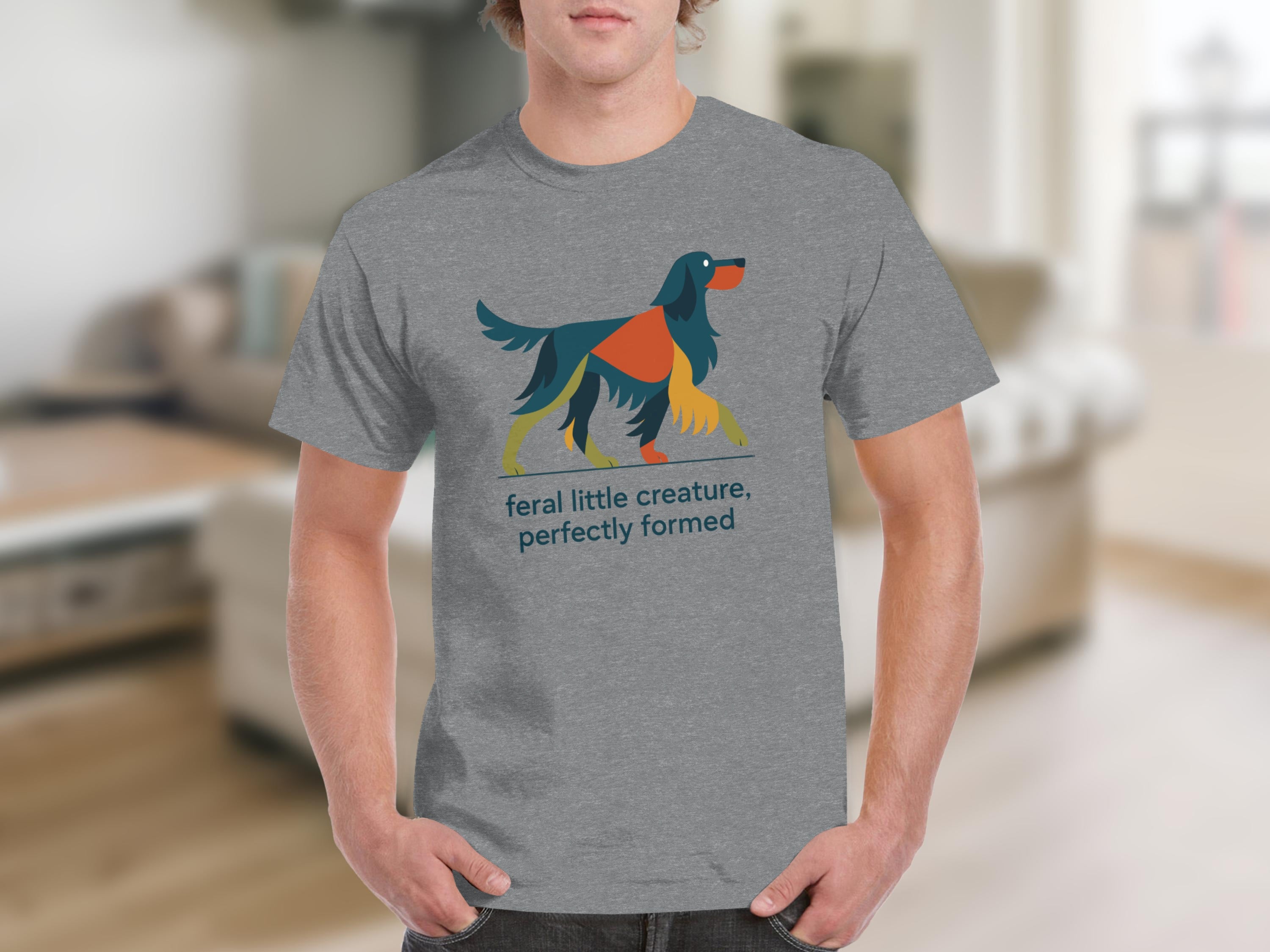 Grey t-shirt with graphic of abstract dog and text "feral little creature, perfectly formed".