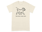 T-shirt with line drawing of a dog on a leash and text "Slow down, enjoy walks".
