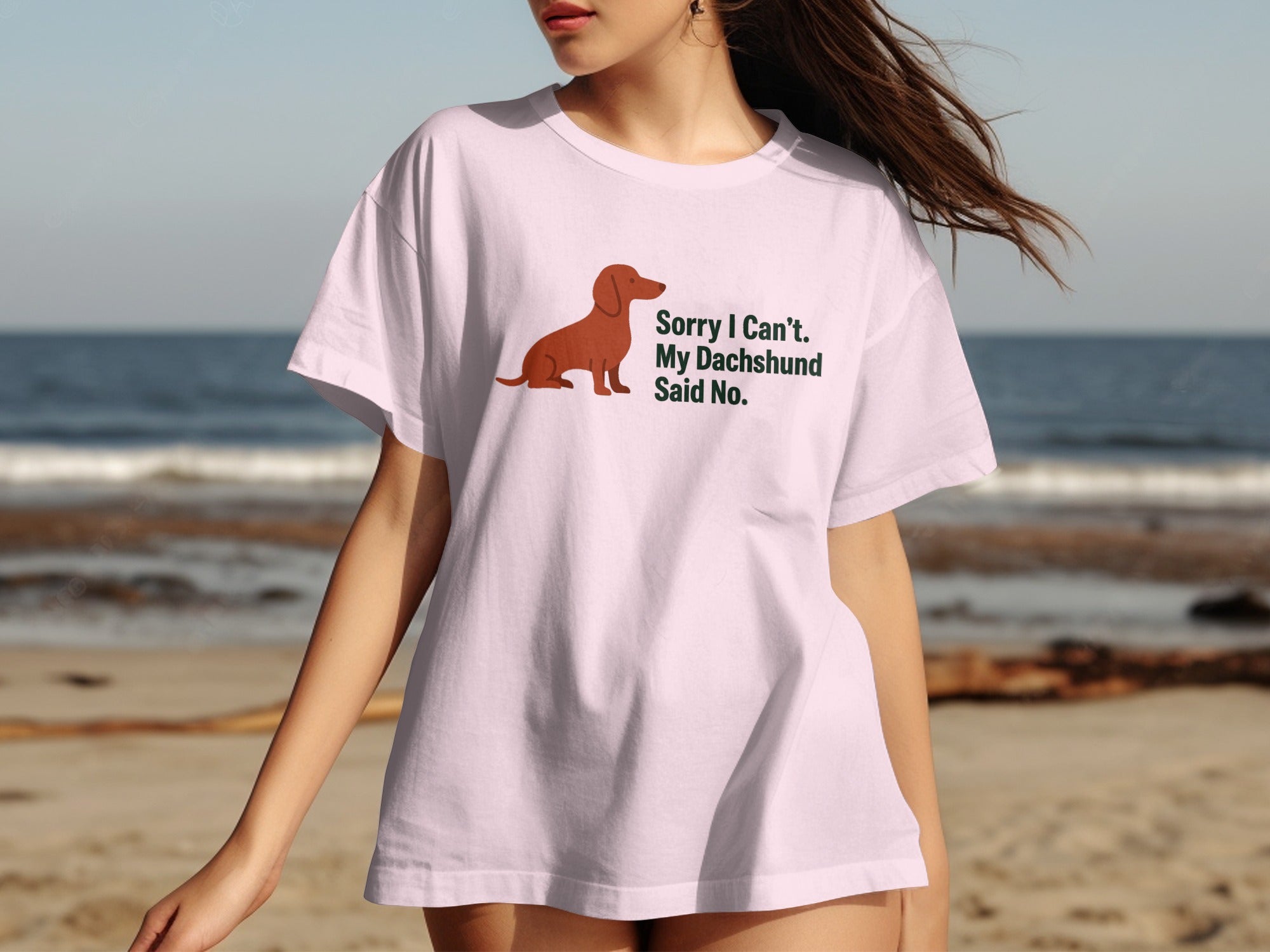 Pink t-shirt with a dachshund illustration and "Sorry I Can't. My Dachshund Said No." text.