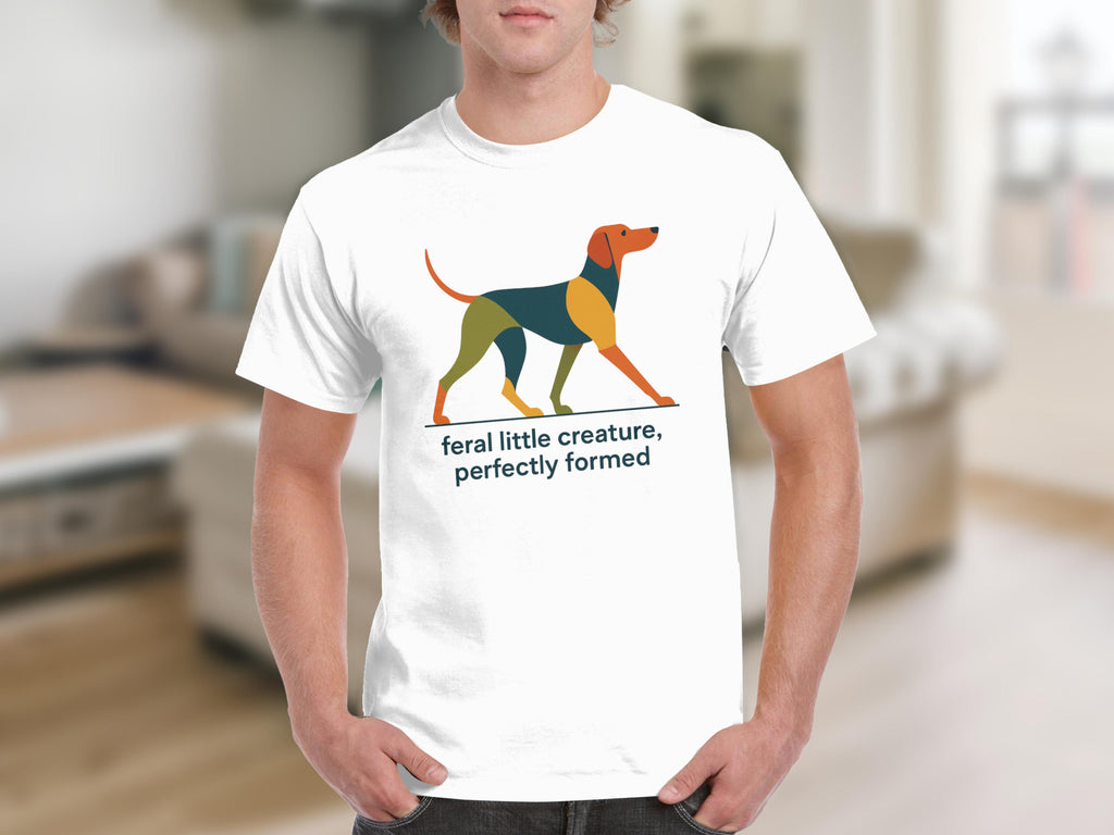 White t-shirt with abstract dog graphic and text "feral little creature, perfectly formed".