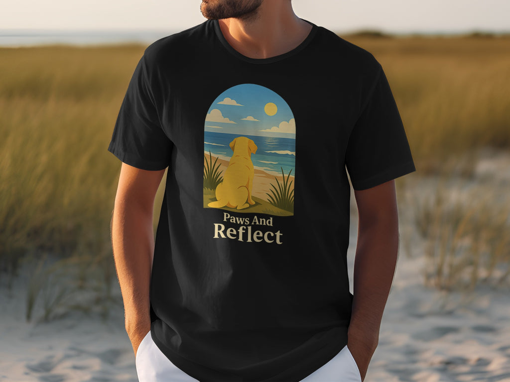 Black t-shirt with a yellow lab looking at the ocean, text "Paws And Reflect".