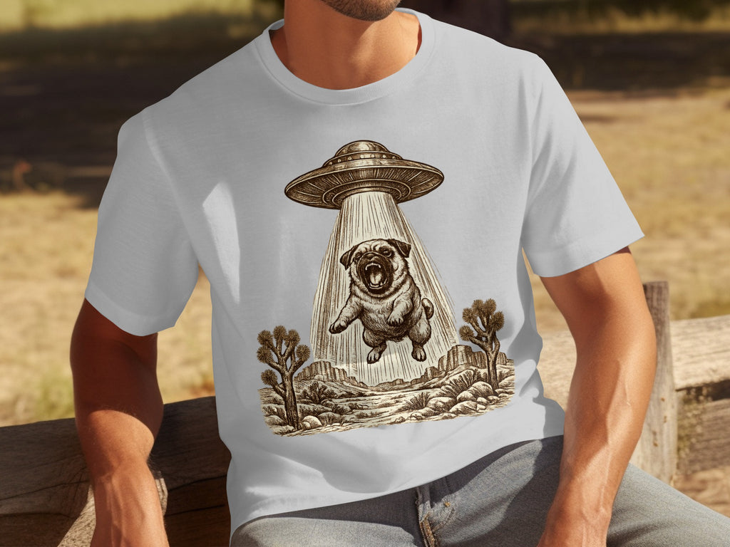 T-shirt graphic of a pug being abducted by a UFO in a desert landscape.
