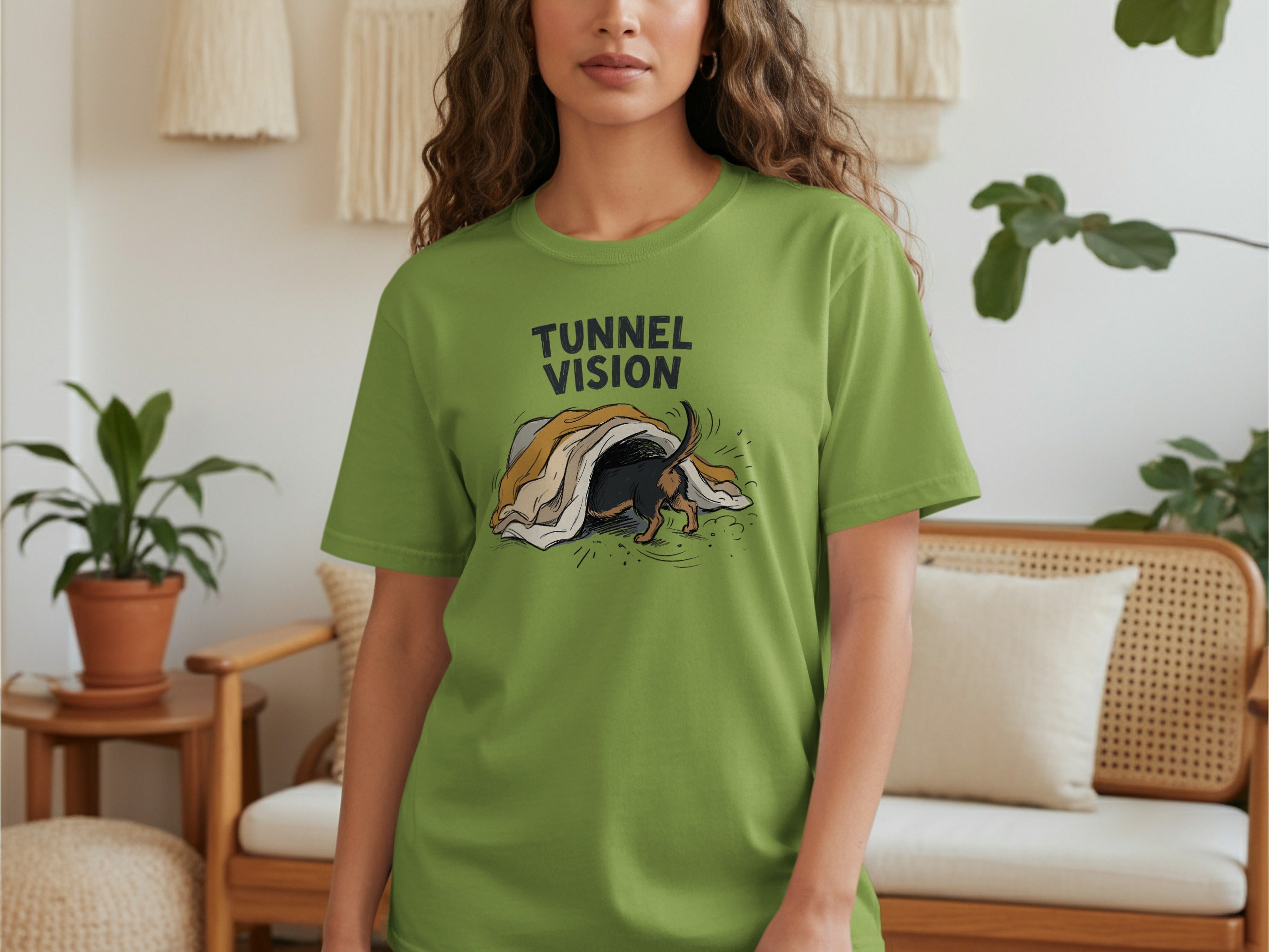 Green t-shirt with a dachshund peeking out from under a blanket.