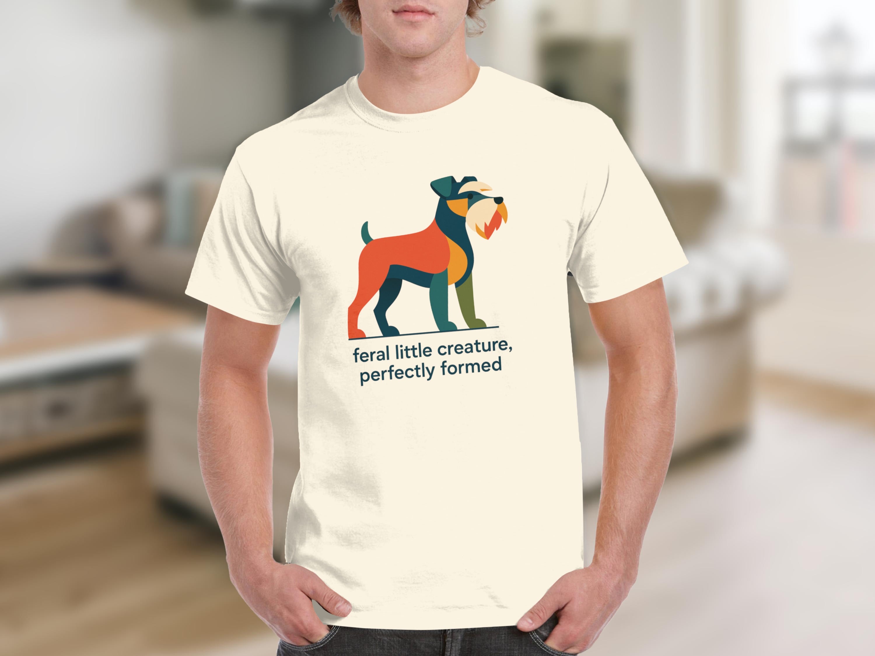 Cream t-shirt with colorful abstract dog and text: "feral little creature, perfectly formed."
