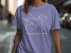 Purple t-shirt with line drawing of a dog and the text "Slow down, enjoy walks."
