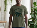 Green t-shirt with a dark green graphic of a dog with "TRUST THE NOSE" text.