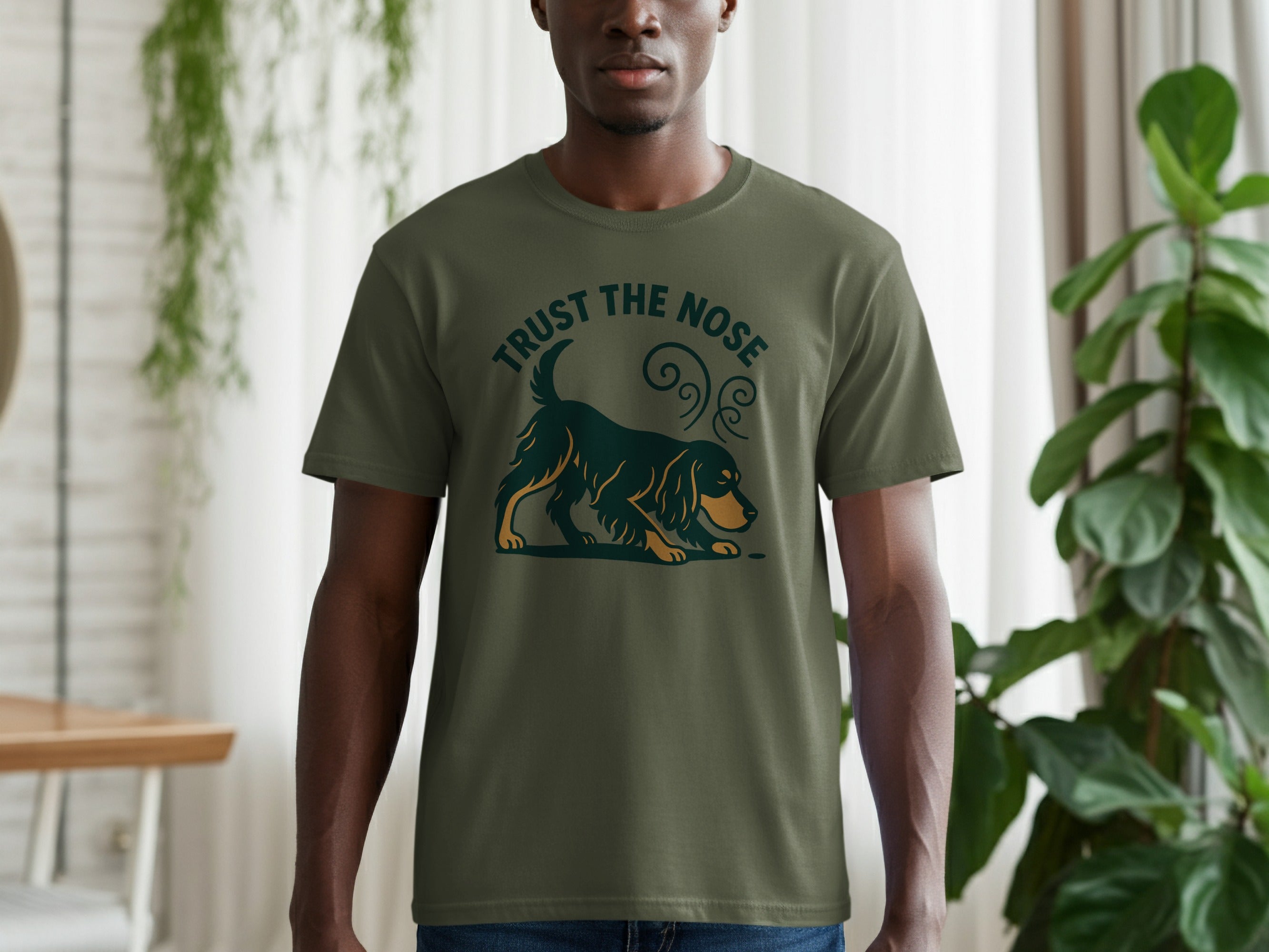 Green t-shirt with a dark green graphic of a dog with "TRUST THE NOSE" text.