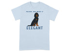 Light blue t-shirt with black dog and text "VELCRO, BUT MAKE IT ELEGANT".