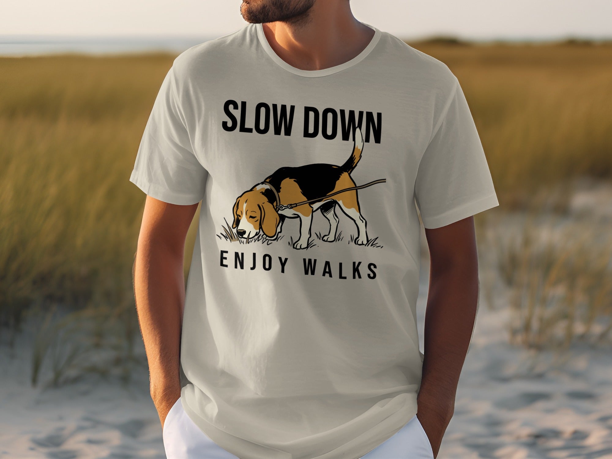 Man wearing a light gray t-shirt with "SLOW DOWN ENJOY WALKS" text and dog graphic.