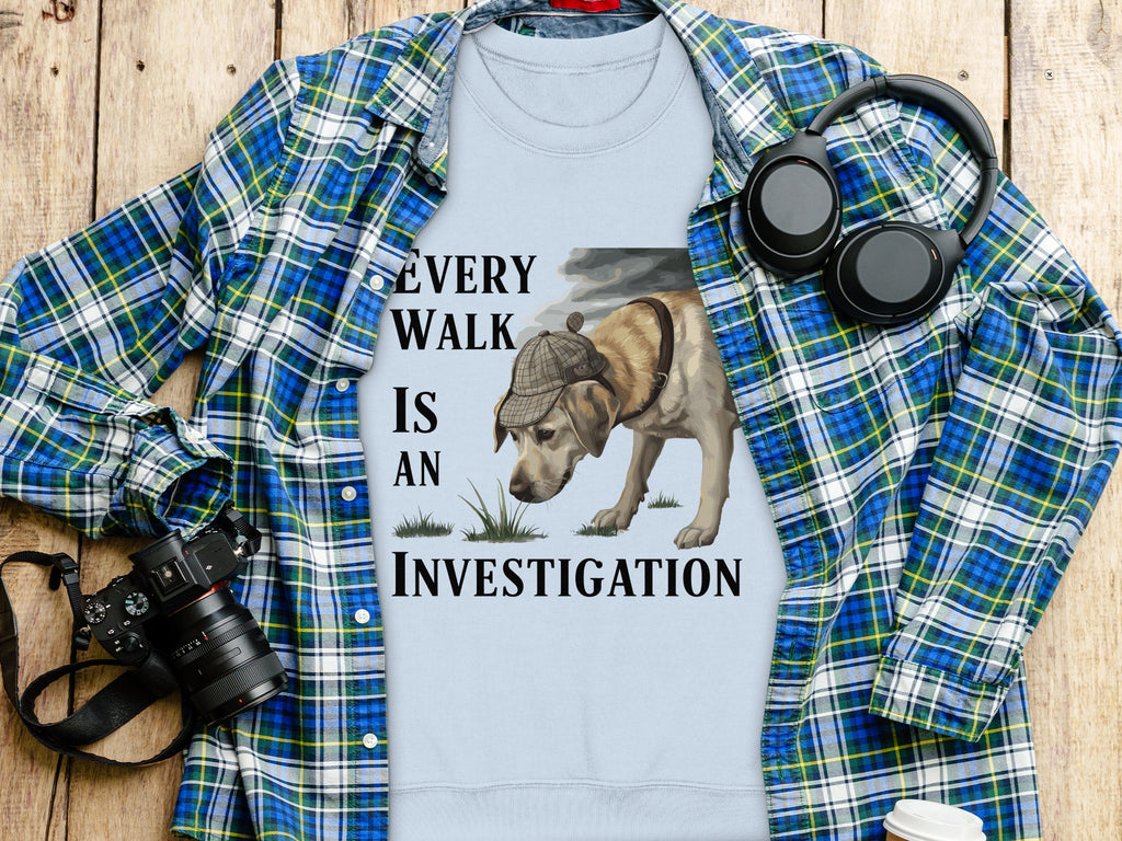 Light blue t-shirt with "Every walk is an investigation" text and dog graphic.