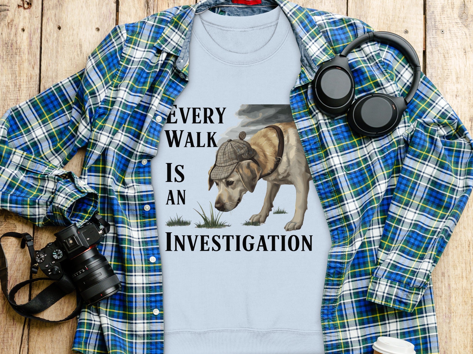 Light blue t-shirt with "Every walk is an investigation" text and dog graphic.