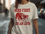 Red and white border collie on a t-shirt with text: HERD FIRST. EXPLAIN LATER.