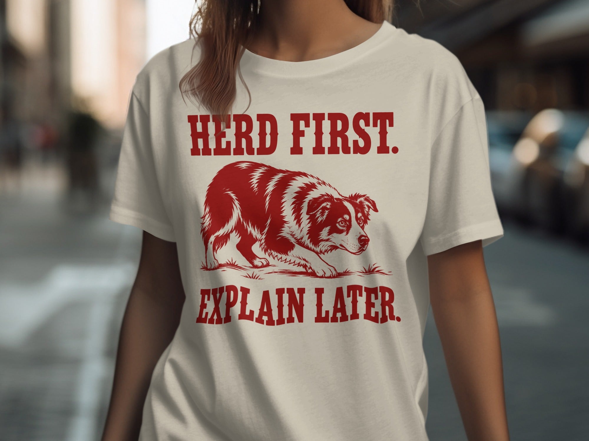 Red and white border collie on a t-shirt with text: HERD FIRST. EXPLAIN LATER.