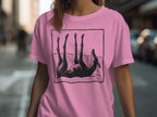 Black dog silhouette on a pink t-shirt, lying on its back.