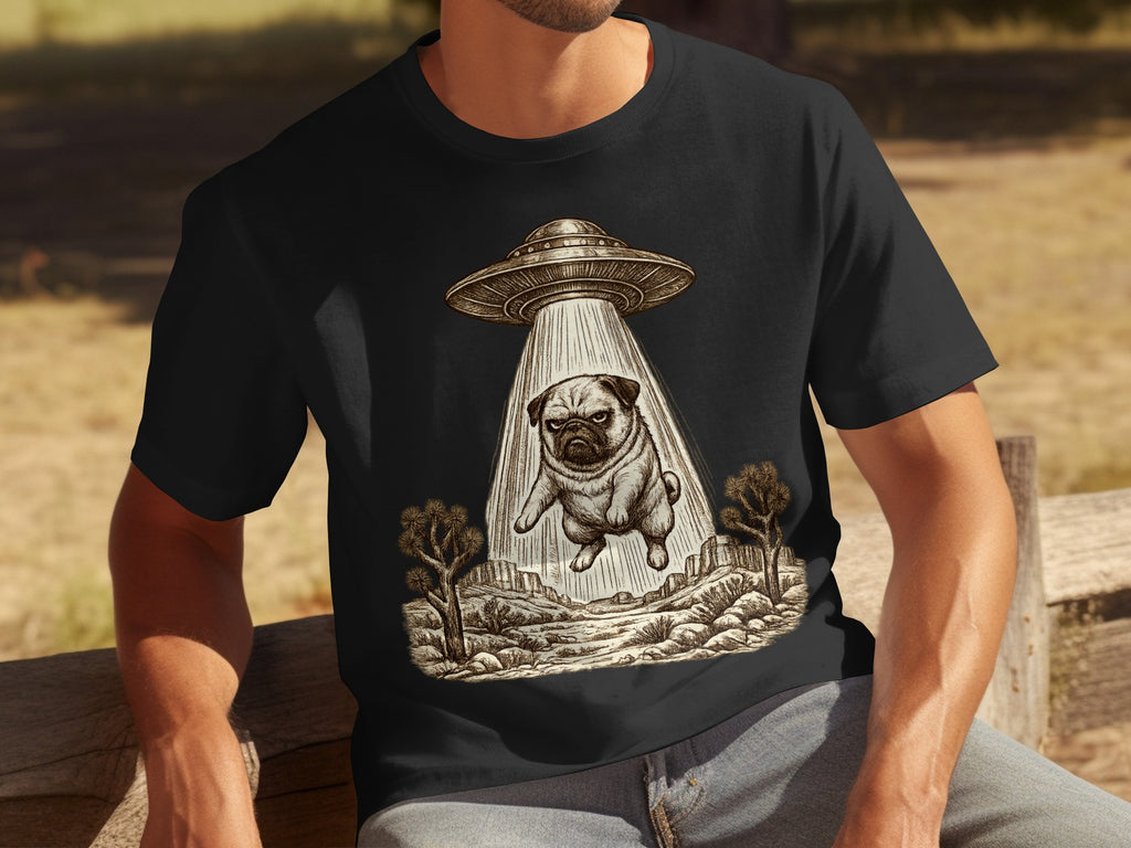 T-shirt with a sketch of a pug being abducted by a UFO over a desert landscape.