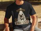 T-shirt with a sketch of a pug being abducted by a UFO over a desert landscape.