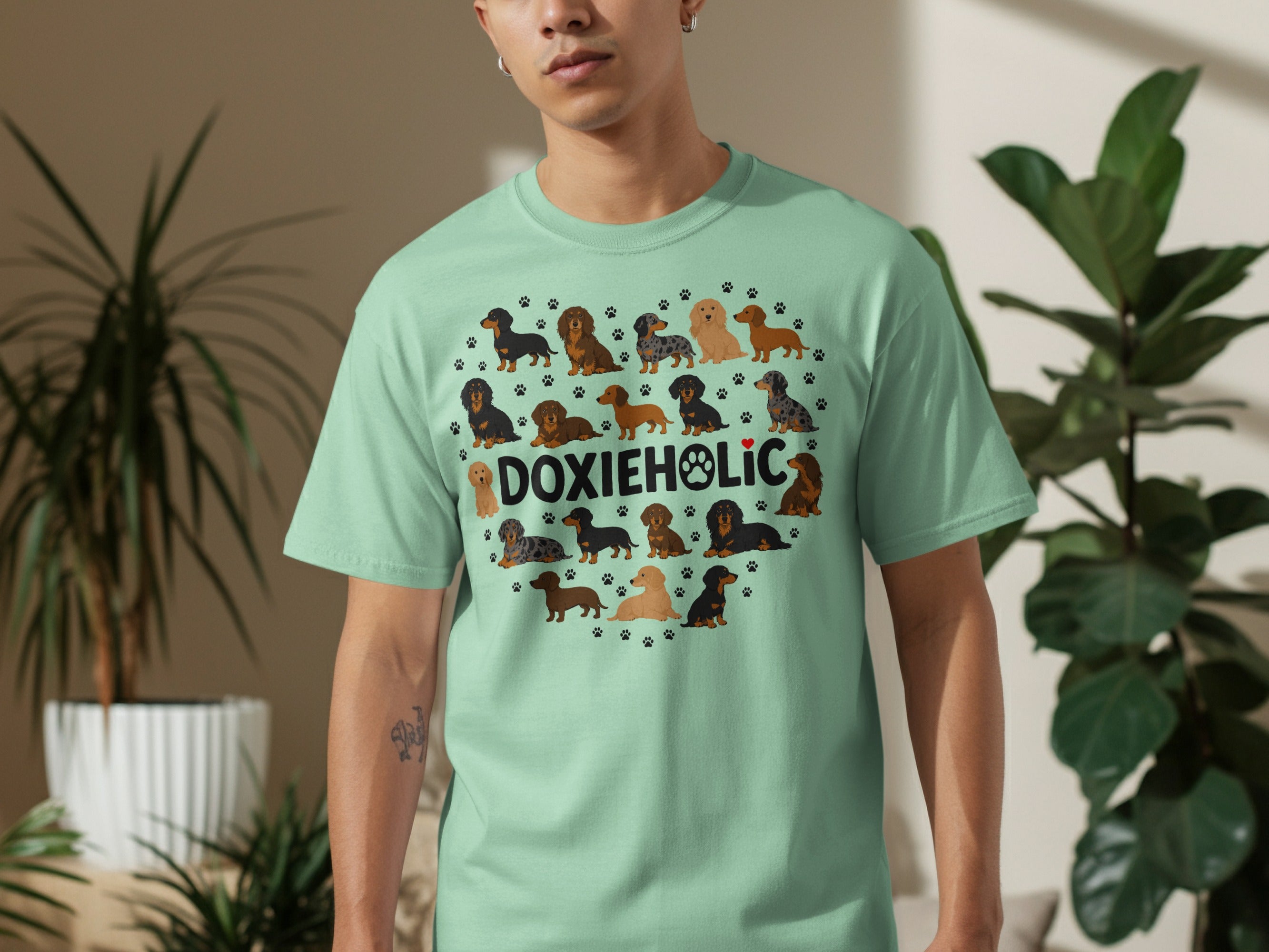 Dachshunds arranged in a heart shape on a light green t-shirt.