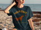 Dark blue t-shirt with "BIRDS FIRST. EVERYTHING ELSE LATER." and dog pointing at bird graphic.