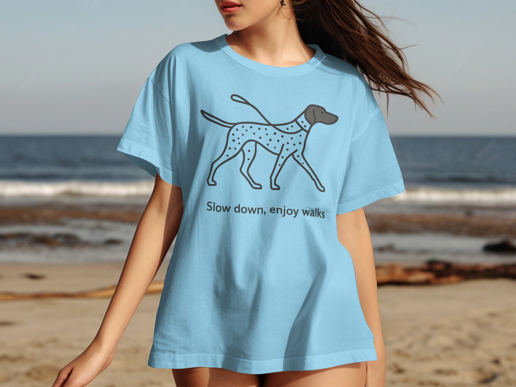 Light blue t-shirt with a graphic of a Dalmatian dog and the text "Slow down, enjoy walks".