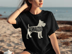 Black t-shirt with white schnauzer silhouette and text on a beach.