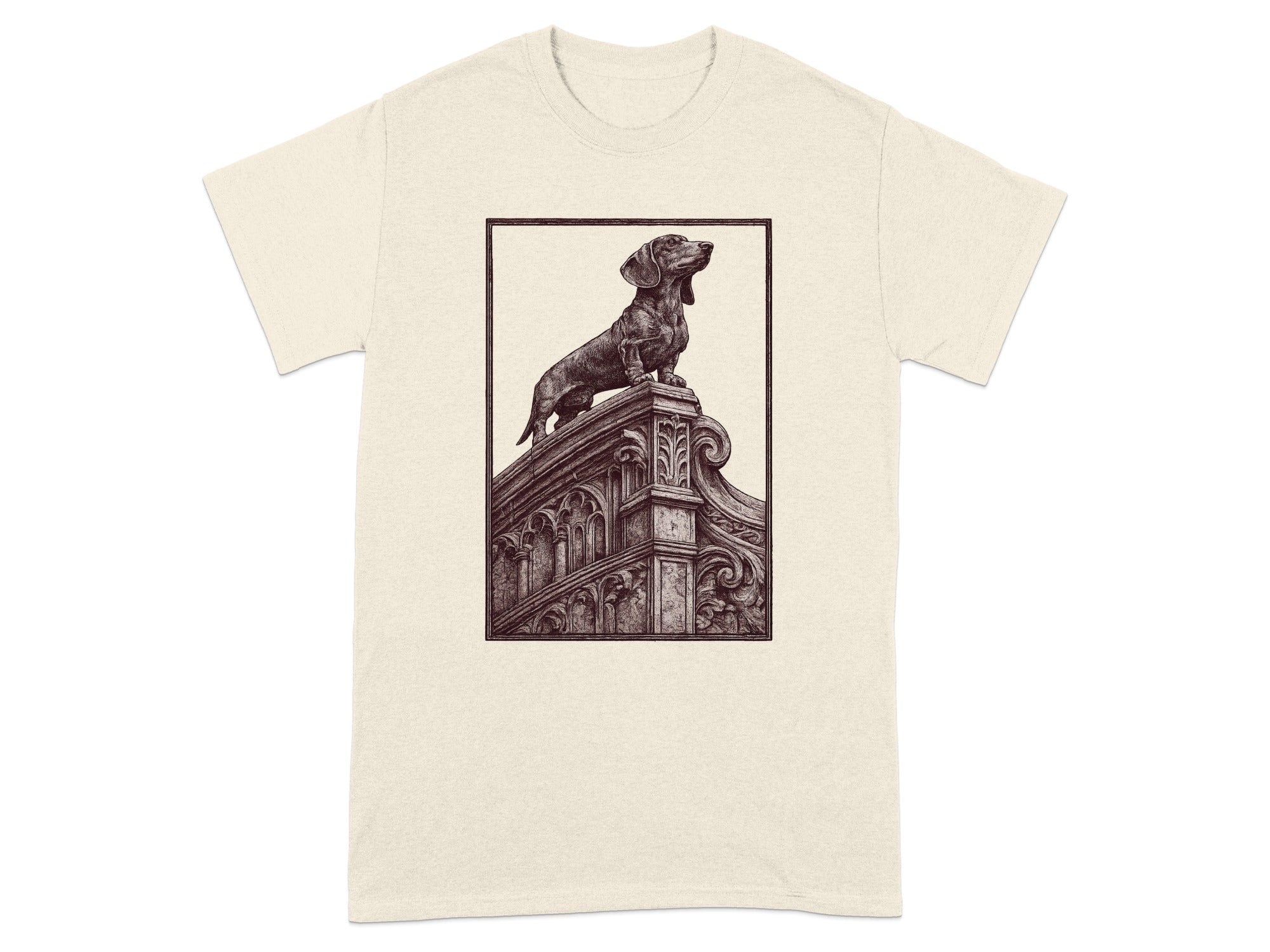 Dachshund statue perched on ornate architecture, within a framed illustration on a cream t-shirt.