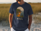 T-shirt with a corgi looking at the ocean and text that reads "Paws And Reflect".