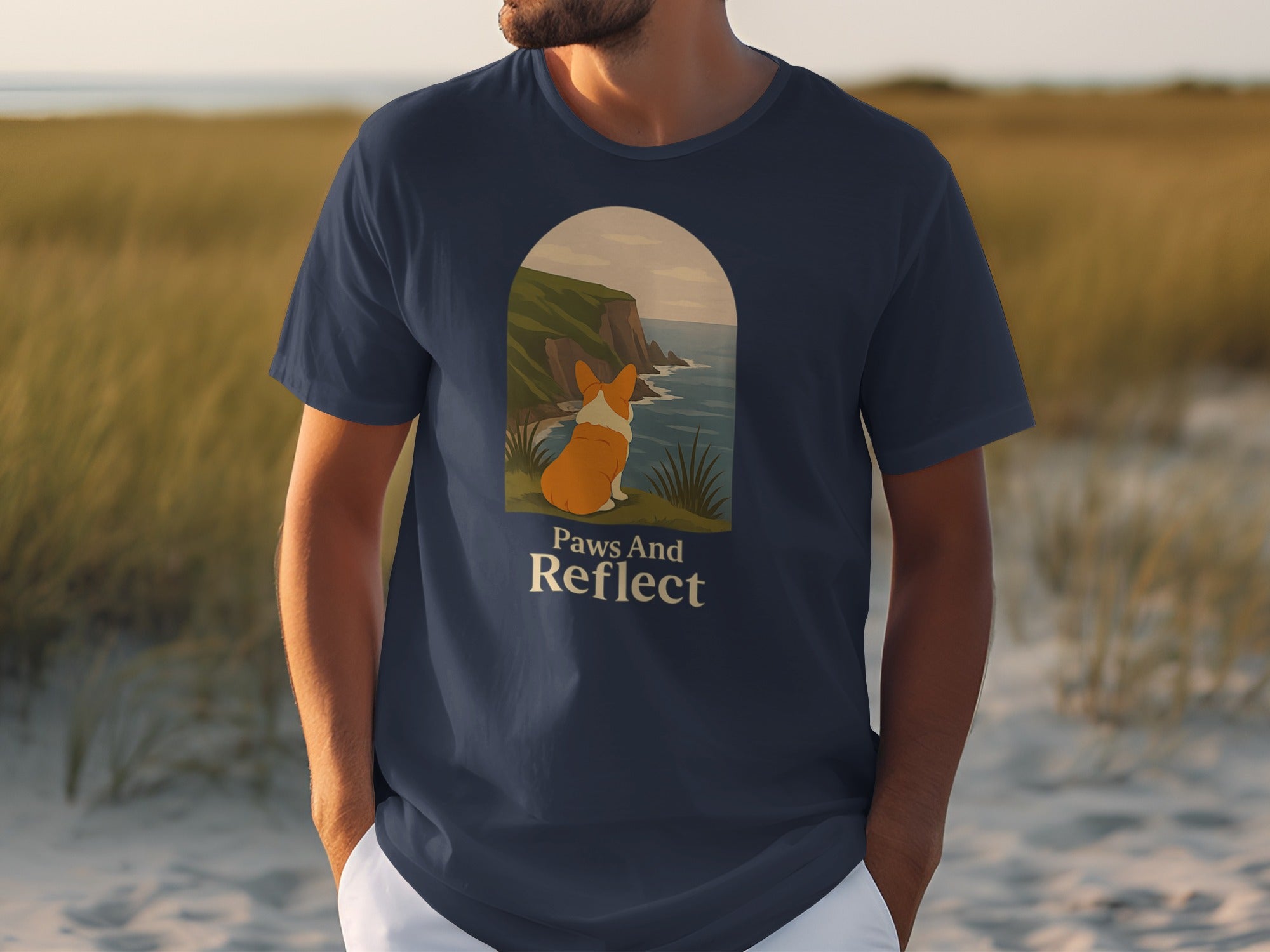 T-shirt with a corgi looking at the ocean and text that reads "Paws And Reflect".