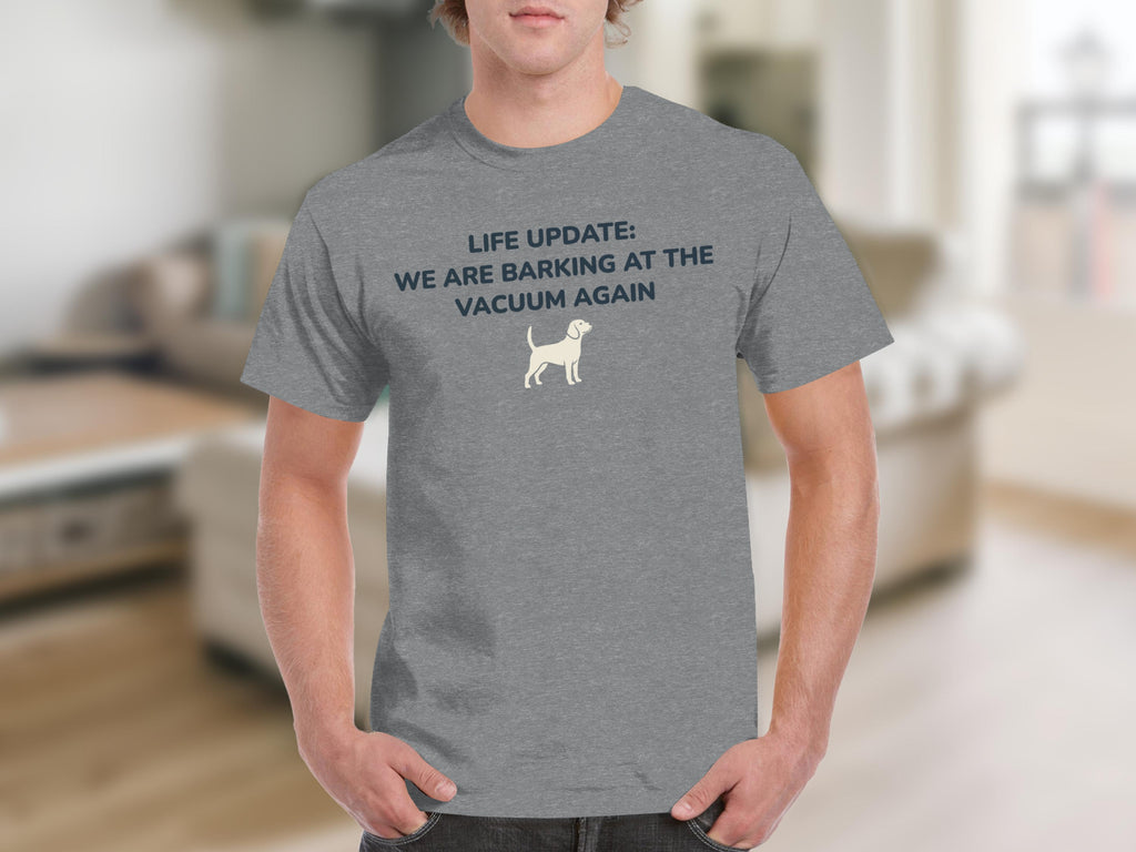 Grey t-shirt with white text: "LIFE UPDATE: WE ARE BARKING AT THE VACUUM AGAIN" and a small dog icon.