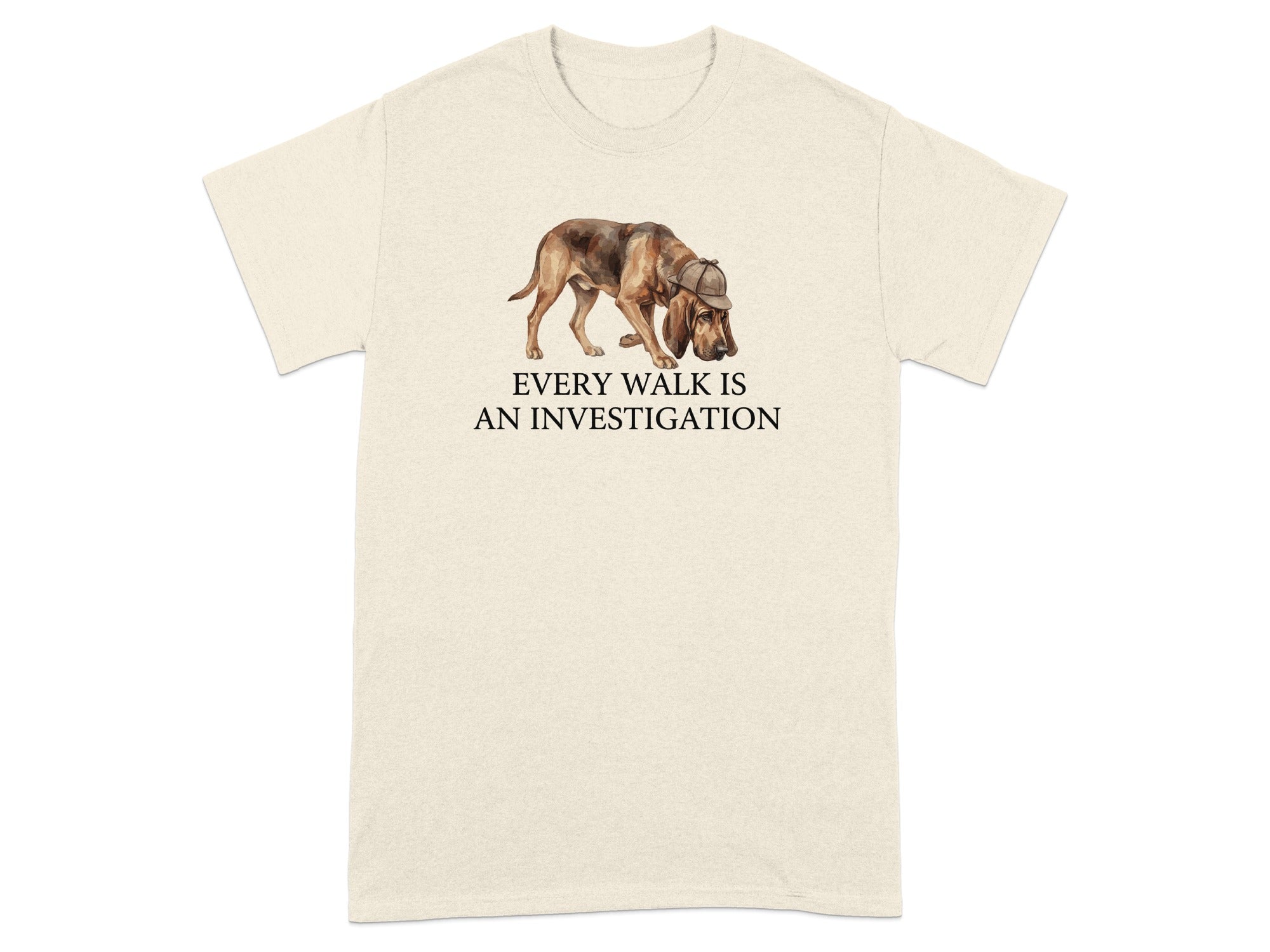 Cream t-shirt with watercolor bloodhound in hat and text "EVERY WALK IS AN INVESTIGATION".