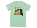 Three pugs, two fawn and one black, sit on a shelf with star and boomerang shapes.