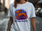 White t-shirt with a running dog illustration and "Unleash the Joy" text.