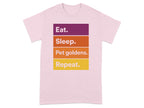 Pink t-shirt with "Eat. Sleep. Pet goldens. Repeat." in colorful blocks.