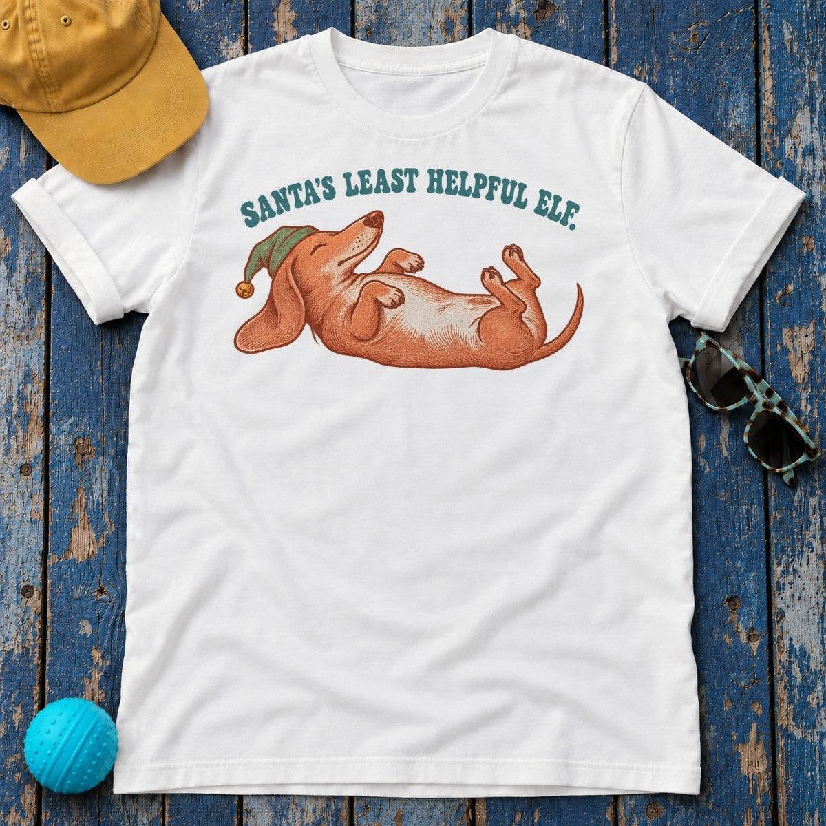 Santa's Least Helpful Elf Dachshund T-Shirt in White - flat lay