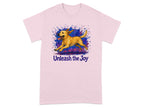 Pink t-shirt with a running yellow dog and purple blue paint splatters. Text reads "Unleash the Joy".