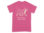 Pink t-shirt with a cream outline graphic of a dog on a leash and text.