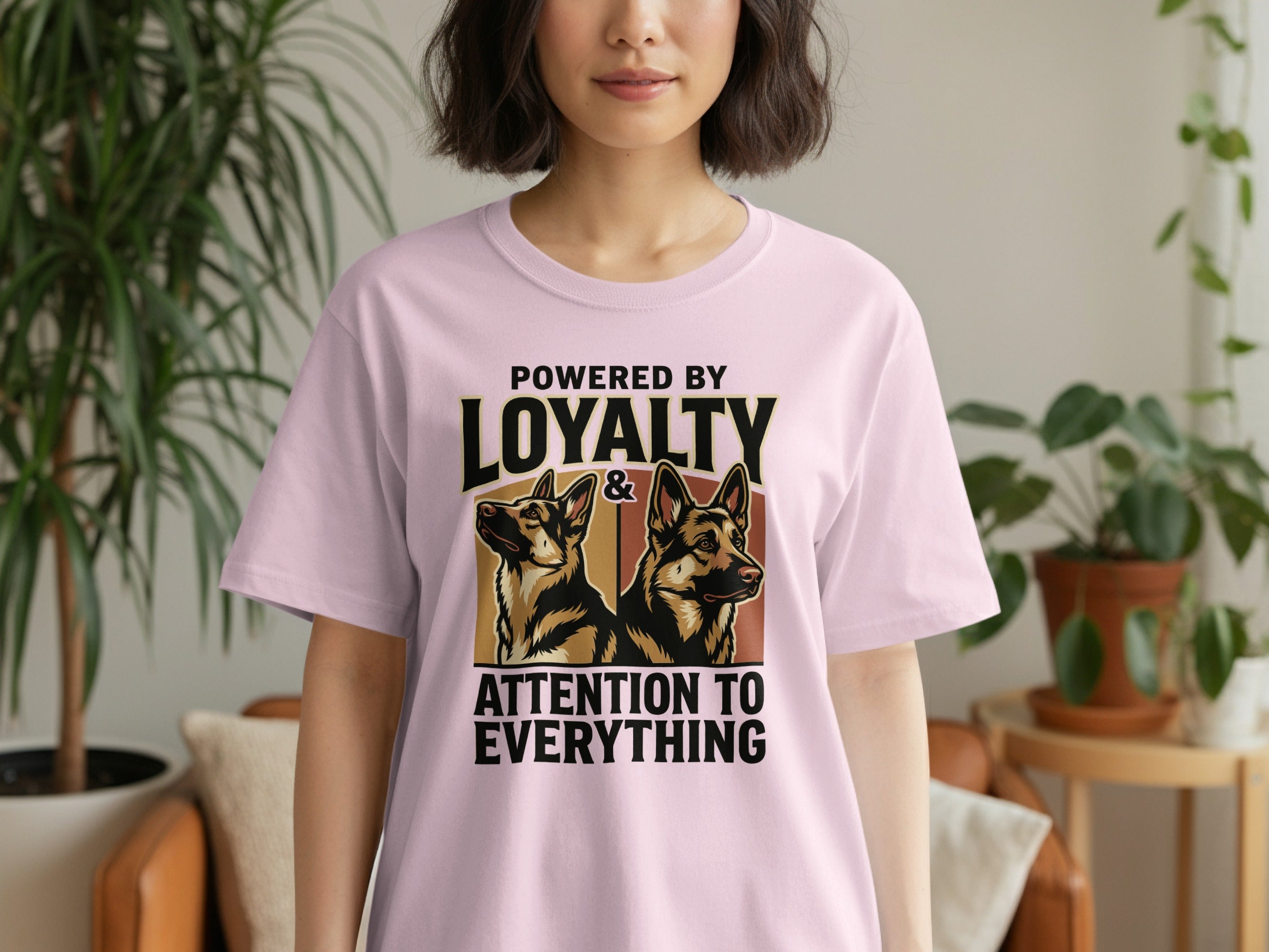 Pink t-shirt with "Powered by Loyalty & Attention to Everything" and two German Shepherds.