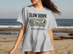 Grey t-shirt with "SLOW DOWN GREYHOUND" and a resting greyhound illustration.