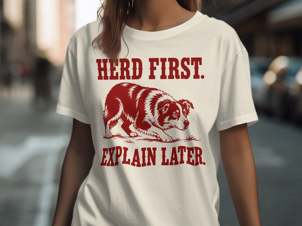 White t-shirt with dog graphic and text "HERD FIRST. EXPLAIN LATER."