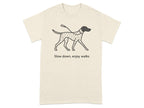 Cream t-shirt with a graphic of a Dalmatian dog and the text "Slow down, enjoy walks".