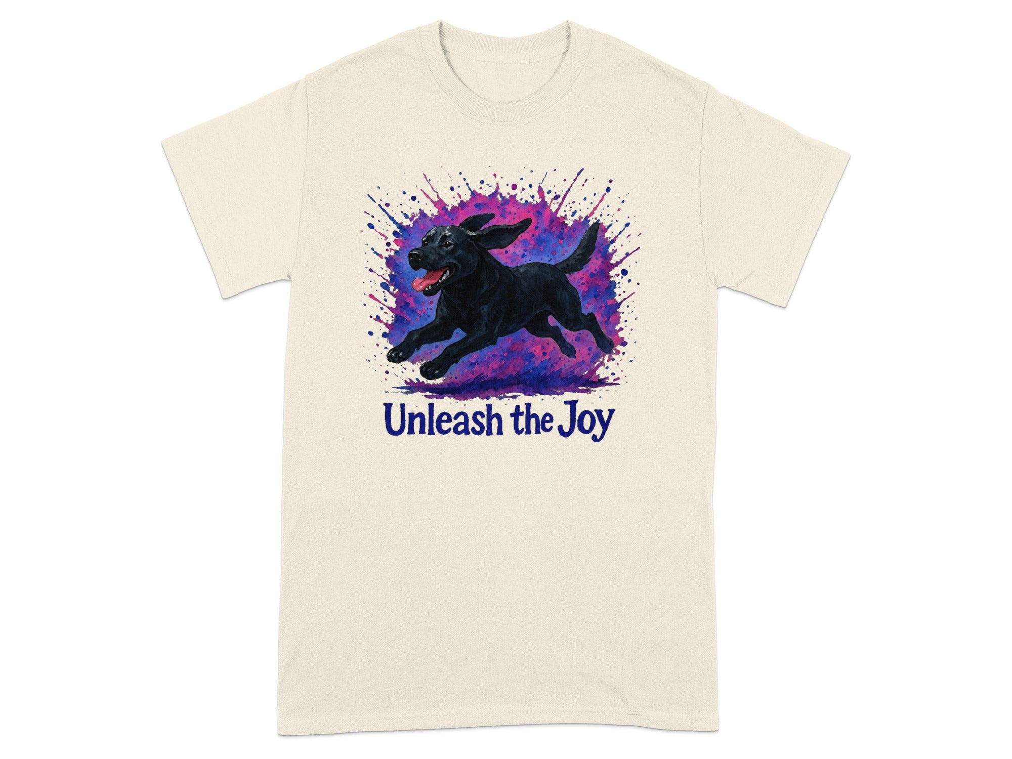 Cream t-shirt with black dog running through colorful paint splatters and text "Unleash the Joy".