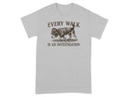 Grey t-shirt with a dog wearing a detective hat and text "EVERY WALK IS AN INVESTIGATION."