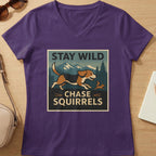 Purple v-neck t-shirt with "STAY WILD CHASE SQUIRRELS" text and beagle chasing squirrel graphic.