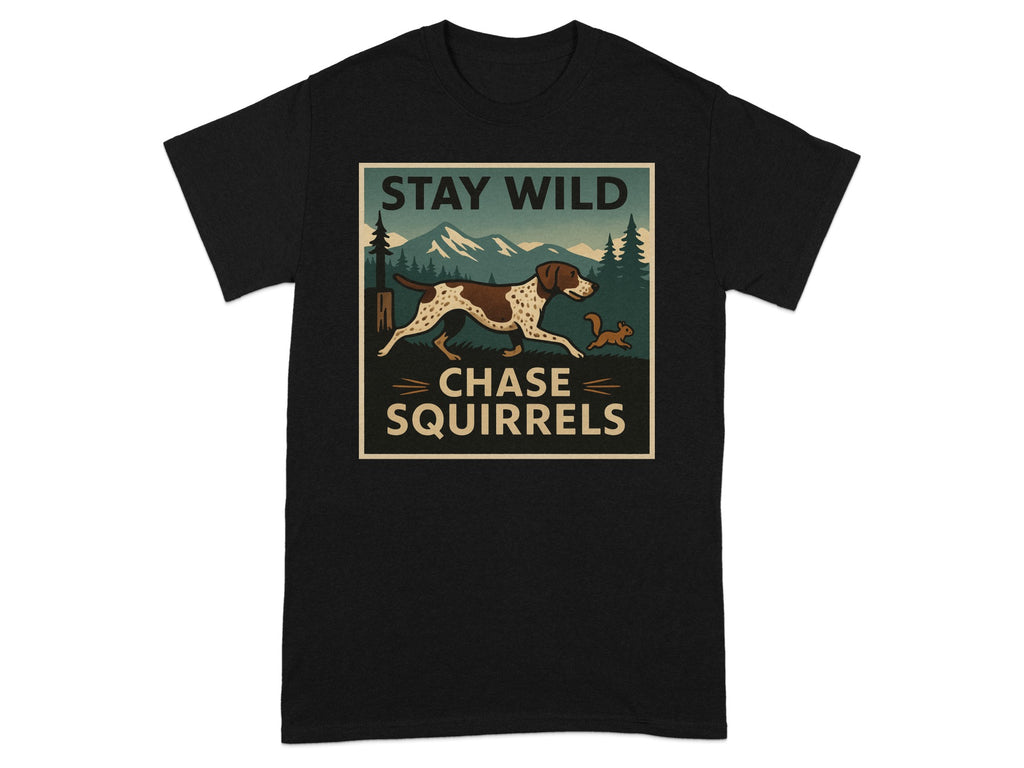 Black t-shirt with graphic of dog chasing squirrel, in a mountain landscape, with text "STAY WILD CHASE SQUIRRELS".